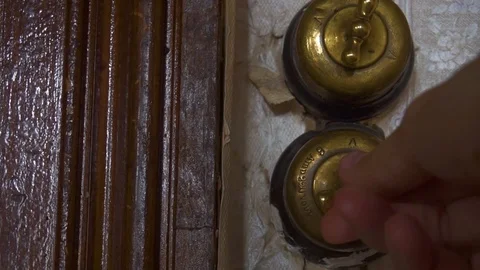 Close-up view of man's hand turning old switch on and off in an old flat of 18th Stock Footage 110785378