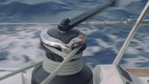 Close up view of man's hand twisting rope on winch of sailing yacht. Stock Footage 93255107