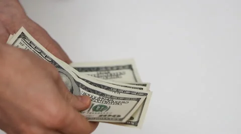 Close up view of man’s hands count hundred dollar bills and give some money away Stock-Footage 60624313