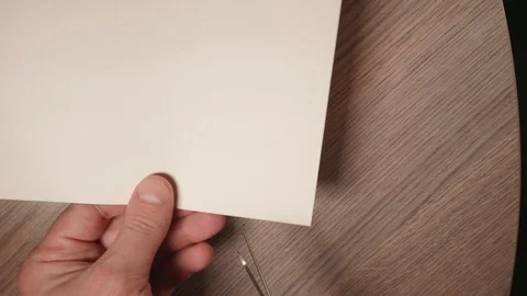 Close up view of man's hands cut big heart from paper using scissors. Up view Stock Footage 124155278