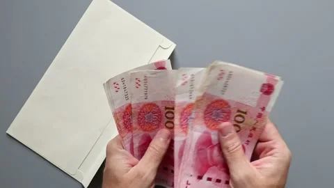Close up view of mans hands, envelope and Chinese Yuan cash money banknotes. Stock Footage 309892216