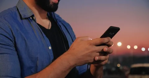 Close up view of Man’s Hands Holding Mobile Device in his Hands.  Stock Footage 97986084