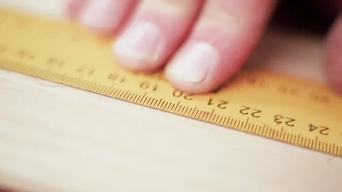 Close up view of a man's hands measuring wooden plank with tape line Stock Footage 69205179
