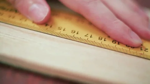 Close up view of a man's hands measuring wooden plank with tape line Stock Footage 69205182