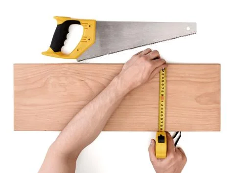 Close up view of a man's hands measuring wooden plank with tape line, isolated Stock Photos