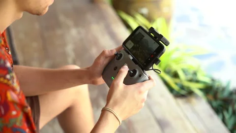 Close-up view of a man's hands operating the remote control of a drone Stock Footage 234861401