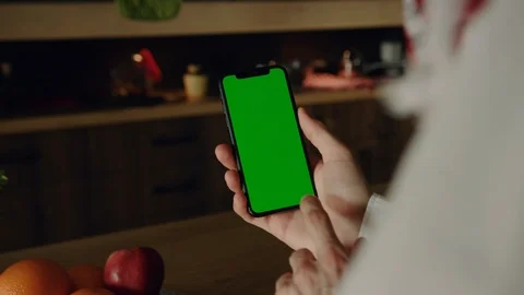 Close up view of man�s hands using vertically green screen mobile phone while Video stock 106316198
