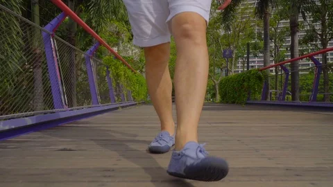 Close up view on man's legs walking on a bridge, Singapore Stock Footage 116556059
