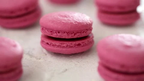 Close-up view of many rows of pink macarons macaroon on white background 스톡 동영상 130237682