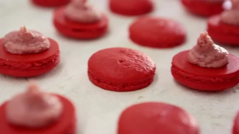 Close-up view of many rows of red opened halves with filling macarons macaroon Video stock 130237973