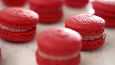 Close-up view of many rows of red macarons macaroon on white background Stock Footage 130673163