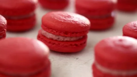 Close-up view of many rows of red macarons macaroon on white background Stock-Footage 130983602