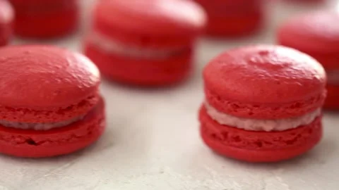 Close-up view of many rows of red macarons macaroon on white background 스톡 동영상 130983614