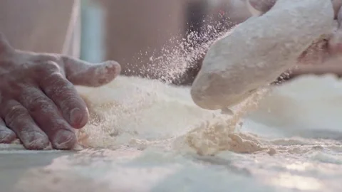 Close up view of married baker’s hands kneading the dough on the table Stock Footage