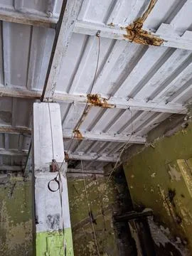 Close view of a massive column and decaying ceiling in an old industrial bu.. Stock Photos