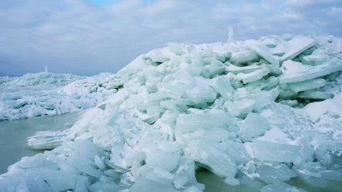 Close view of a massive sea-ice pressure ridge with blue ice slabs and slushy Stock Footage 333033033