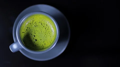 Close-up view of matcha tea on black background Stock Footage 124315443
