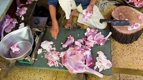 Close view of meat vendor preparing fresh cuts using knife and cleaver Stock-Footage 329091048