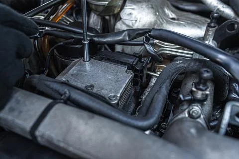 Close-up view of a mechanic using a tool to work on a car engine Stock Photos