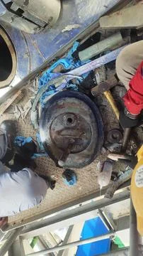 A close-up view of a mechanical assembly with tools and parts on a work sur.. Stock Photos