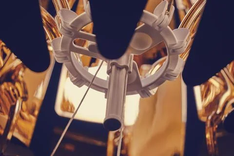 Close-up view of a mechanical component with white and gold elements. Abstrac Stock Photos