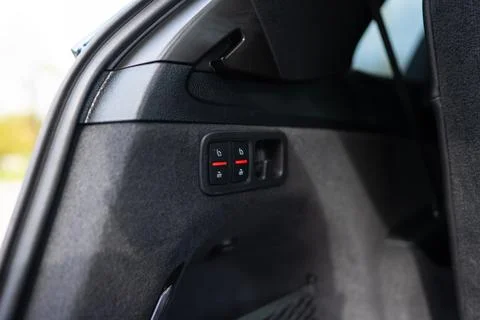 Close up view of mechanical lever located on left side of rear trunk for folding Stock Photos