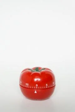 Close up view of mechanical tomato shaped kitchen clock timer for cooking and Stock Photos