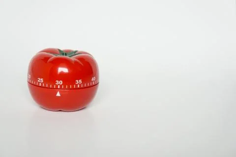 Close up view of mechanical tomato shaped kitchen clock timer for cooking and Stock Photos