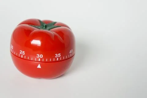 Close up view of mechanical tomato shaped kitchen clock timer for cooking and Stock Photos