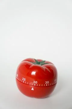 Close up view of mechanical tomato shaped kitchen clock timer for cooking and Stock Photos