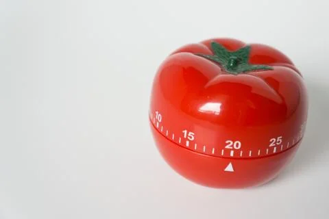 Close up view of mechanical tomato shaped kitchen clock timer for cooking and Stock Photos