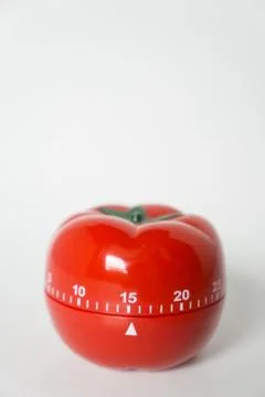Close up view of mechanical tomato shaped kitchen clock timer for cooking and Stock Photos