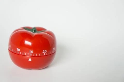 Close up view of mechanical tomato shaped kitchen clock timer for cooking and Stock Photos