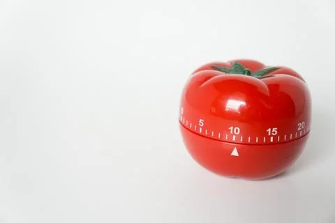 Close up view of mechanical tomato shaped kitchen clock timer for cooking and Stock Photos