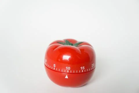 Close up view of mechanical tomato shaped kitchen clock timer for cooking and Stock Photos