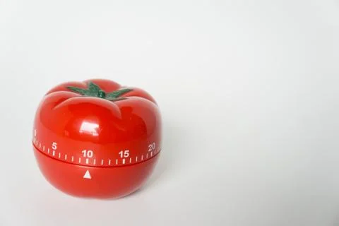 Close up view of mechanical tomato shaped kitchen clock timer for cooking and Stock Photos