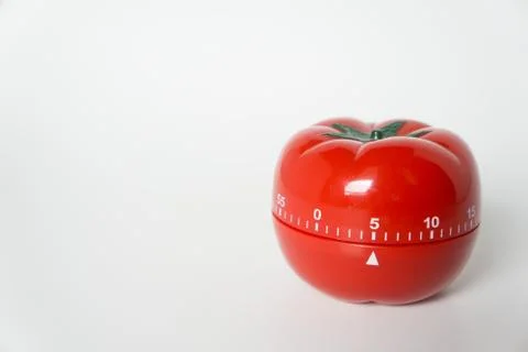 Close up view of mechanical tomato shaped kitchen clock timer for cooking and Stock Photos