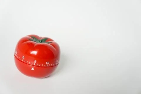 Close up view of mechanical tomato shaped kitchen clock timer for cooking and Stock Photos