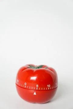 Close up view of mechanical tomato shaped kitchen clock timer for cooking and Stock Photos
