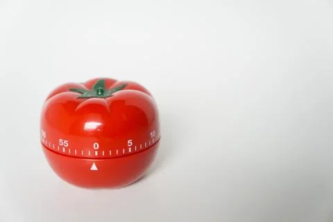 Close up view of mechanical tomato shaped kitchen clock timer for cooking and Stock Photos