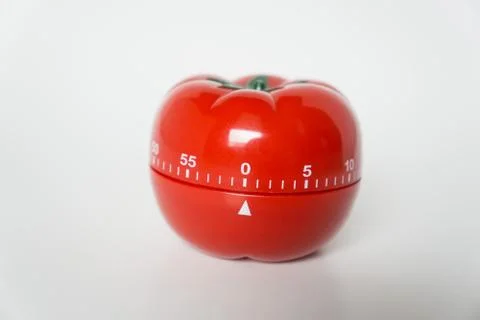 Close up view of mechanical tomato shaped kitchen clock timer for cooking and Stock Photos
