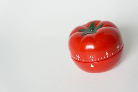 Close up view of mechanical tomato shaped kitchen clock timer for cooking and Stock Photos