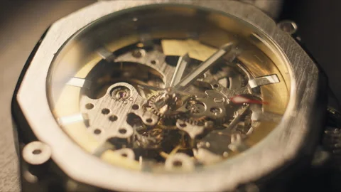 Close view of a mechanical watch showing inner gears and movements at a workshop Stock Footage 336224750