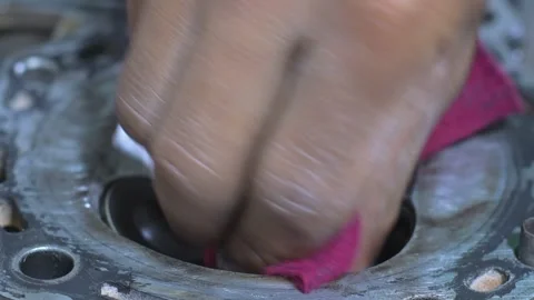 Close-up view of a mechanic's hands performing valve maintenance on an engine 스톡 동영상 312253456