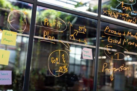 Close up view of memo notes on window glass at modern office Stock Photos