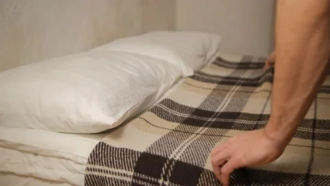 Close-up view of men's hands making the bed in the room, touching the pillows, p Stock Footage 147934683