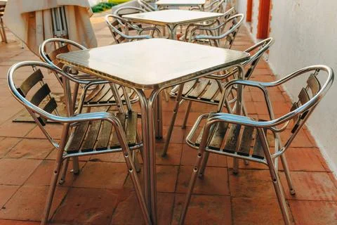 Close view of metal café table and chairs outdoors Stock Photos