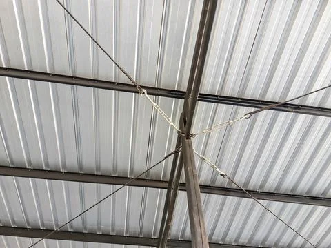 Close-up view of a metal rooftop structure with supporting cables and a cor.. Stock Photos