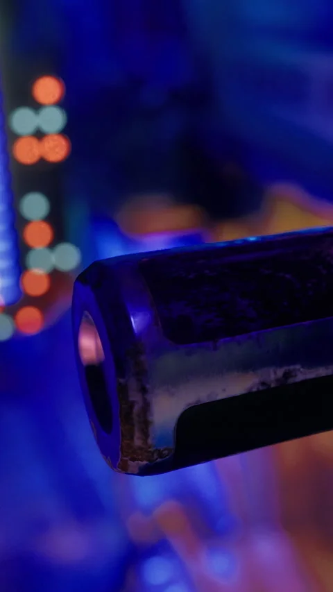Close view of a metallic object with colorful lights in the background Stock Footage 331766784