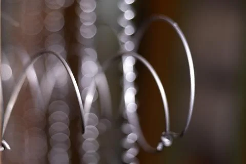 Close-up view of metallic wire loops with a blurred background, showcasing .. Stock Photos